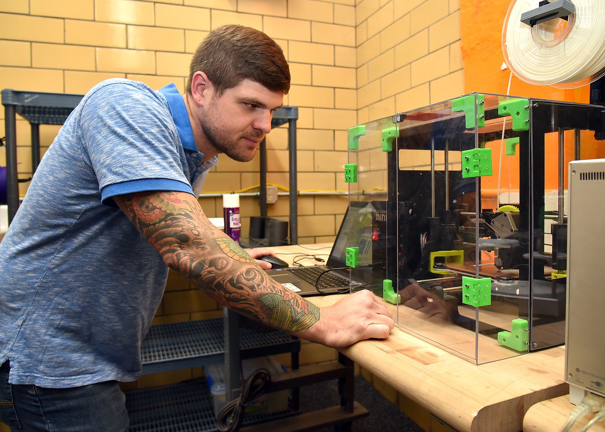 Alex Weber works in the Tickle College of Engineering 3 D modeling lab.